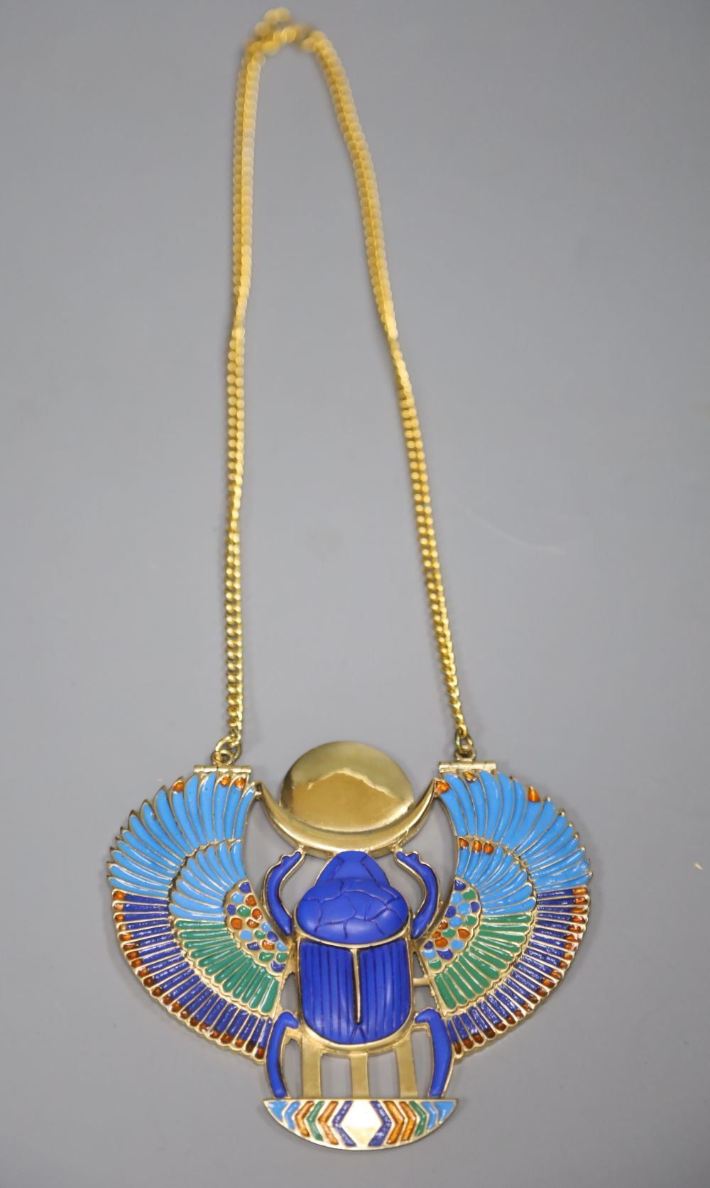 An Egyptian design gilt metal and enamel scarab beetle pendant on chain, by Thomas Fattorini Ltd